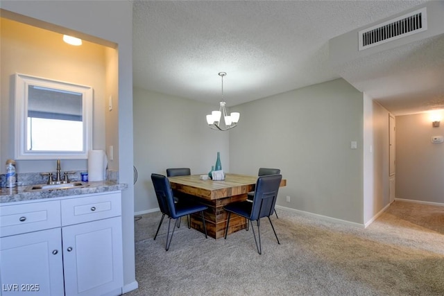 745 N Royal Crest Cir Unit 127, Las Vegas, NV 89169 - dining room featuring light carpet, a chandelier, a textured ceiling, and baseboards