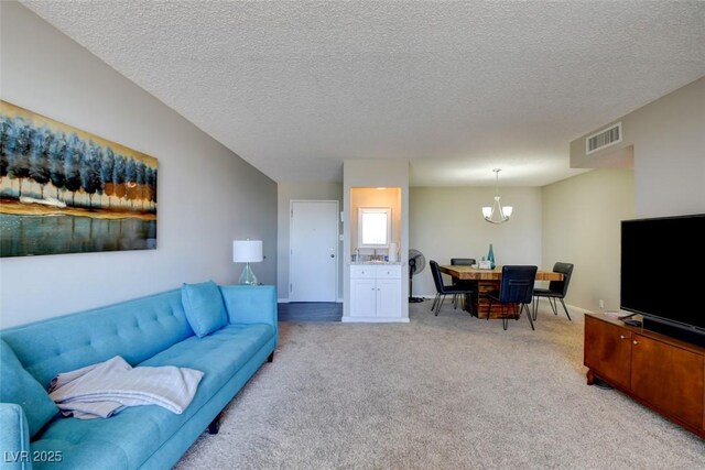 745 N Royal Crest Cir Unit 127, Las Vegas, NV 89169 - living area with a chandelier, light carpet, and a textured ceiling