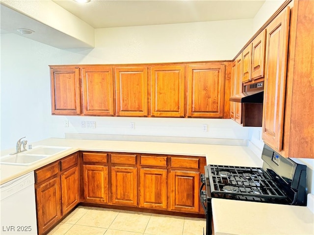 5653 Mount Athos St, North Las Vegas, NV 89031 - kitchen featuring range with gas stovetop, dishwasher, a sink, under cabinet range hood, and brown cabinetry