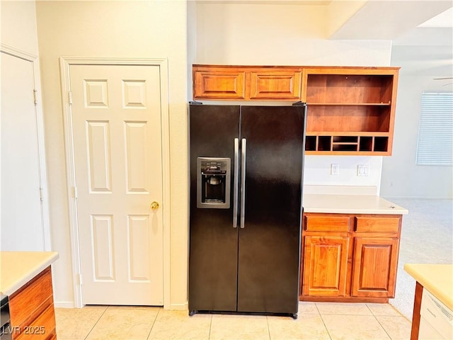 5653 Mount Athos St, North Las Vegas, NV 89031 - kitchen with black fridge with ice dispenser, light tile patterned flooring, light countertops, and open shelves