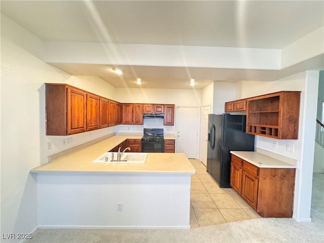 5653 Mount Athos St, North Las Vegas, NV 89031 - kitchen with black appliances, a peninsula, light countertops, a sink, and open shelves