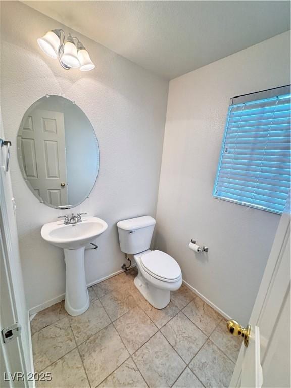 5653 Mount Athos St, North Las Vegas, NV 89031 - half bathroom featuring toilet, baseboards, and tile patterned flooring
