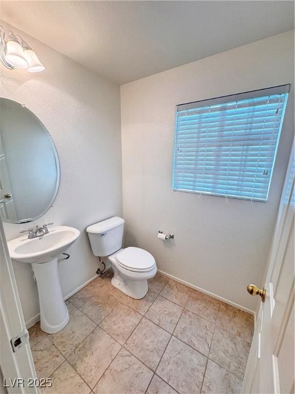 5653 Mount Athos St, North Las Vegas, NV 89031 - half bathroom featuring toilet and baseboards