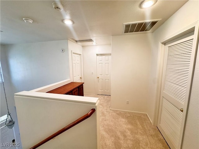 5653 Mount Athos St, North Las Vegas, NV 89031 - hallway featuring light carpet and baseboards