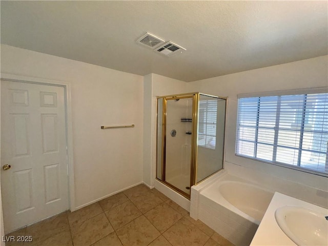 5653 Mount Athos St, North Las Vegas, NV 89031 - full bathroom with a bath, a shower stall, a sink, tile patterned flooring, and baseboards