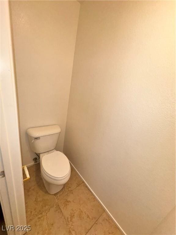 5653 Mount Athos St, North Las Vegas, NV 89031 - bathroom with toilet, baseboards, and tile patterned flooring