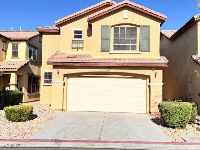 5653 Mount Athos St, North Las Vegas, NV 89031 - view of front of house with a garage, a tiled roof, stucco siding, and driveway