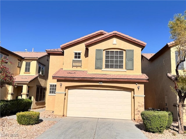 5653 Mount Athos St, North Las Vegas, NV 89031 - view of front of home with a garage, a tiled roof, driveway, and stucco siding