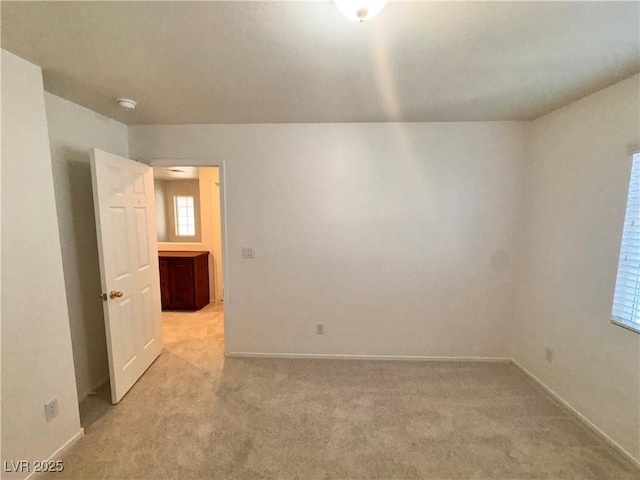 5653 Mount Athos St, North Las Vegas, NV 89031 - unfurnished room featuring baseboards and light carpet