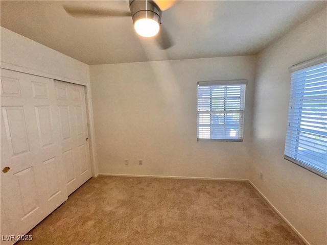 5653 Mount Athos St, North Las Vegas, NV 89031 - unfurnished bedroom featuring light carpet, multiple windows, and baseboards