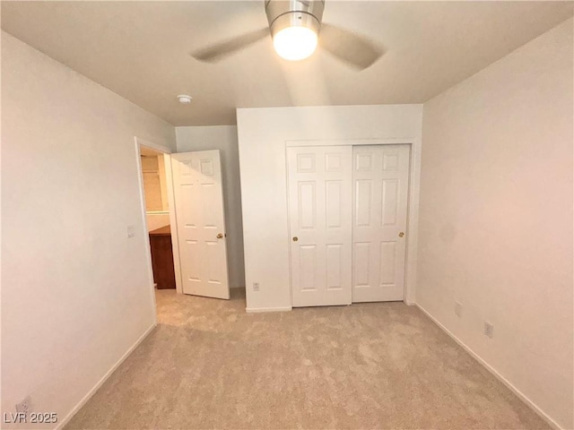 5653 Mount Athos St, North Las Vegas, NV 89031 - unfurnished bedroom with light colored carpet, baseboards, a closet, and a ceiling fan