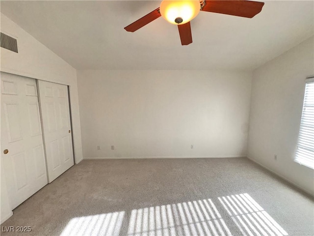 5653 Mount Athos St, North Las Vegas, NV 89031 - unfurnished bedroom with carpet, vaulted ceiling, a closet, ceiling fan, and baseboards