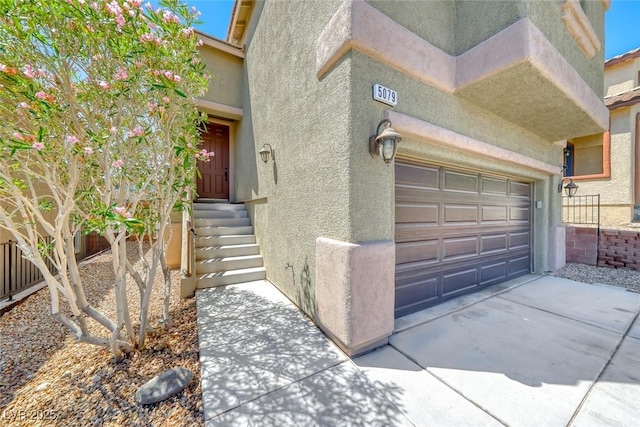 5079 Quiet Falls Ct, Las Vegas, NV 89141 - entrance to property featuring a garage, stucco siding, and driveway