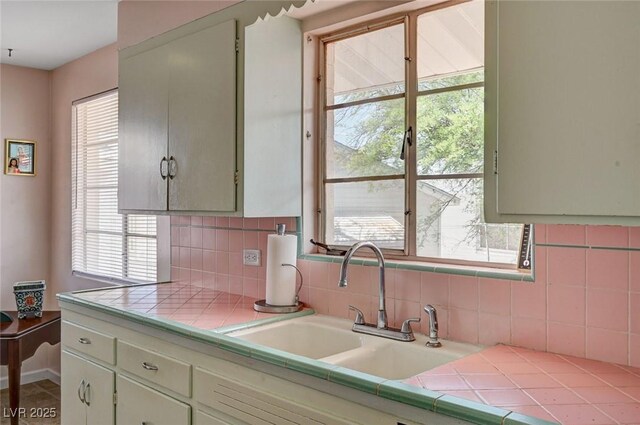 557 6th St, Boulder City, NV 89005 - kitchen featuring a sink, tile countertops, and tasteful backsplash