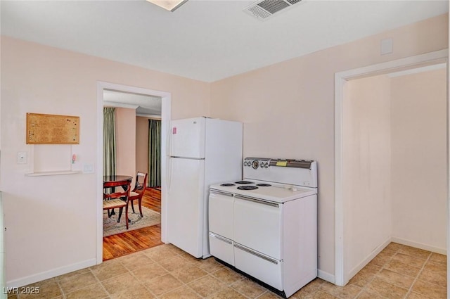 557 6th St, Boulder City, NV 89005 - kitchen featuring white appliances, baseboards, and light countertops