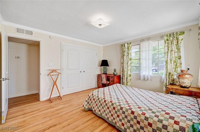 557 6th St, Boulder City, NV 89005 - bedroom with wood finished floors, crown molding, a closet, and baseboards