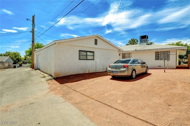 557 6th St, Boulder City, NV 89005 - view of front of home featuring stucco siding and cooling unit