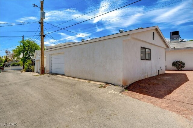 557 6th St, Boulder City, NV 89005 - view of side of home featuring stucco siding