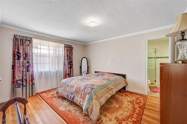 557 6th St, Boulder City, NV 89005 - bedroom with wood finished floors, crown molding, baseboards, and connected bathroom