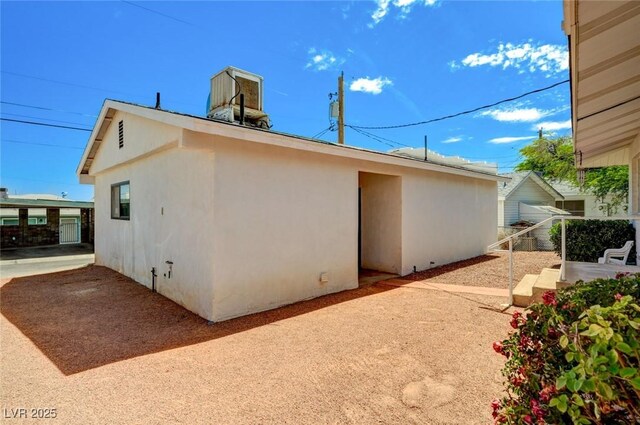 557 6th St, Boulder City, NV 89005 - view of side of property featuring a patio and stucco siding