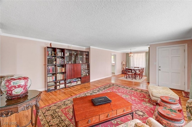557 6th St, Boulder City, NV 89005 - living area featuring wood finished floors, crown molding, a textured ceiling, and baseboards