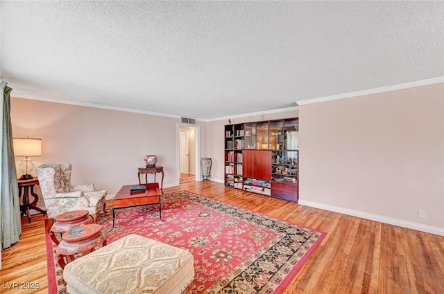557 6th St, Boulder City, NV 89005 - living area with wood finished floors, a textured ceiling, baseboards, and ornamental molding