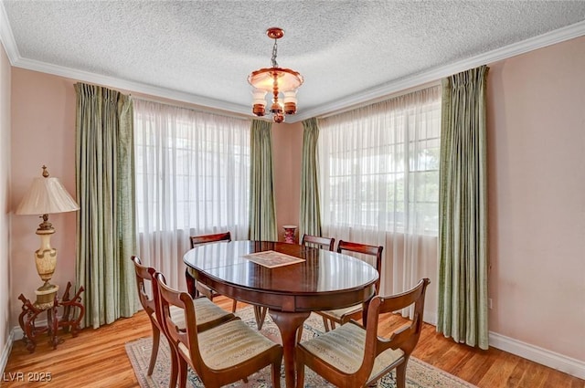 557 6th St, Boulder City, NV 89005 - dining area featuring baseboards, light wood-style flooring, ornamental molding, and a textured ceiling