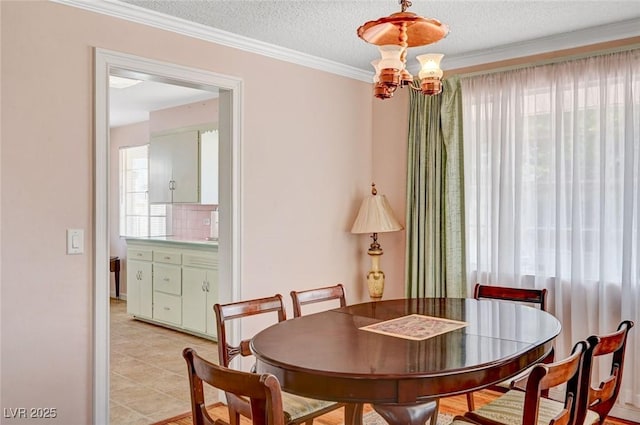 557 6th St, Boulder City, NV 89005 - dining room with ornamental molding, a textured ceiling, a chandelier, and light tile patterned flooring