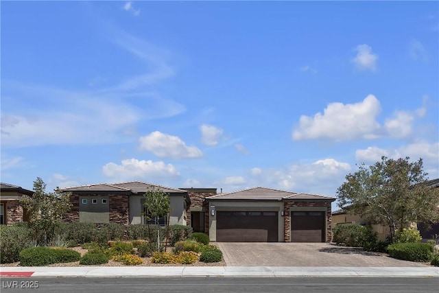 7072 Arabian Ridge St, Las Vegas, NV 89131 - view of front of house featuring stone siding, decorative driveway, and an attached garage