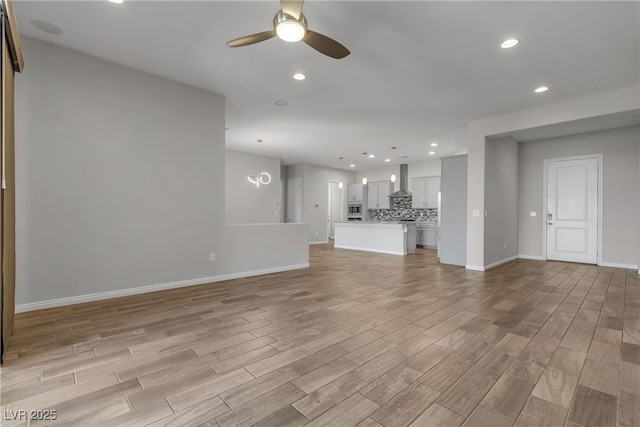 7072 Arabian Ridge St, Las Vegas, NV 89131 - unfurnished living room featuring a ceiling fan, light wood-style floors, baseboards, and recessed lighting