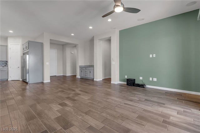 7072 Arabian Ridge St, Las Vegas, NV 89131 - unfurnished living room featuring ceiling fan, wood finished floors, baseboards, and recessed lighting