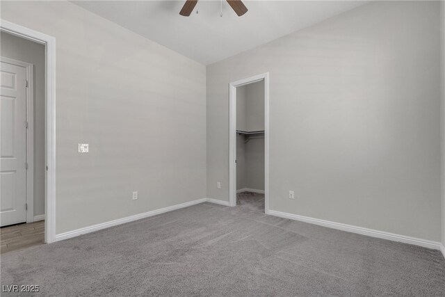 7072 Arabian Ridge St, Las Vegas, NV 89131 - unfurnished bedroom with carpet flooring, baseboards, a walk in closet, and ceiling fan
