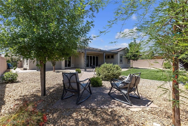 7072 Arabian Ridge St, Las Vegas, NV 89131 - rear view of property featuring stucco siding and a patio