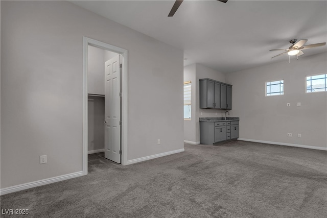 7072 Arabian Ridge St, Las Vegas, NV 89131 - unfurnished living room with a ceiling fan, carpet flooring, baseboards, and a sink