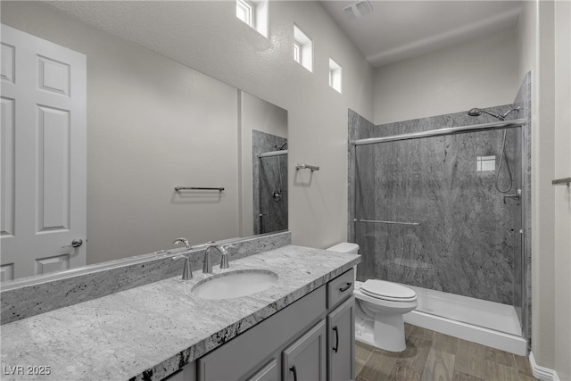7072 Arabian Ridge St, Las Vegas, NV 89131 - full bath with vanity, toilet, a stall shower, and wood finished floors