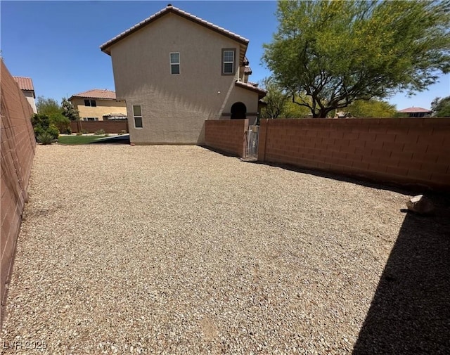8682 Gateway Glen Dr, Las Vegas, NV 89178 - view of property exterior with stucco siding and a gate