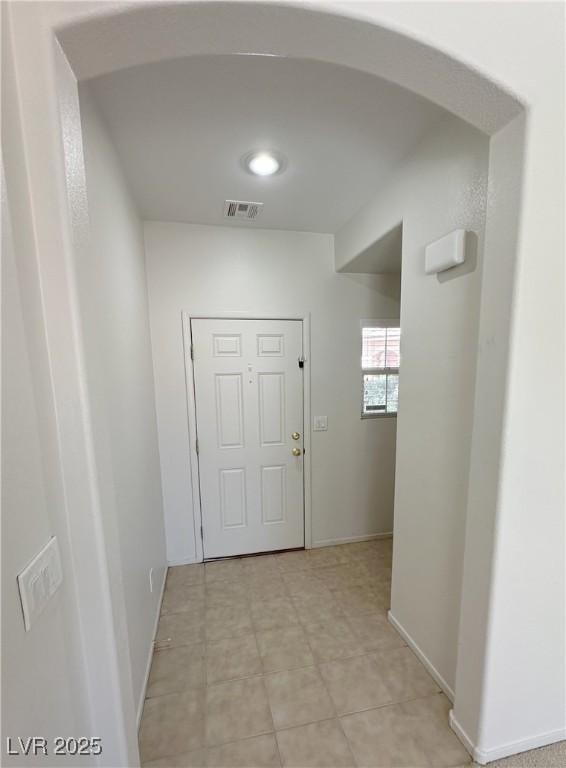 8682 Gateway Glen Dr, Las Vegas, NV 89178 - doorway to outside featuring arched walkways and baseboards