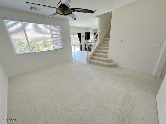 8682 Gateway Glen Dr, Las Vegas, NV 89178 - unfurnished living room with a ceiling fan, carpet flooring, stairway, and baseboards