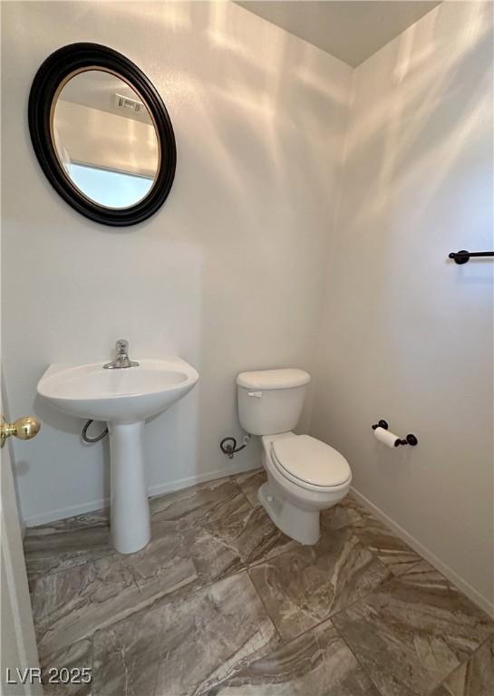 8682 Gateway Glen Dr, Las Vegas, NV 89178 - half bath with toilet, baseboards, and marble finish flooring