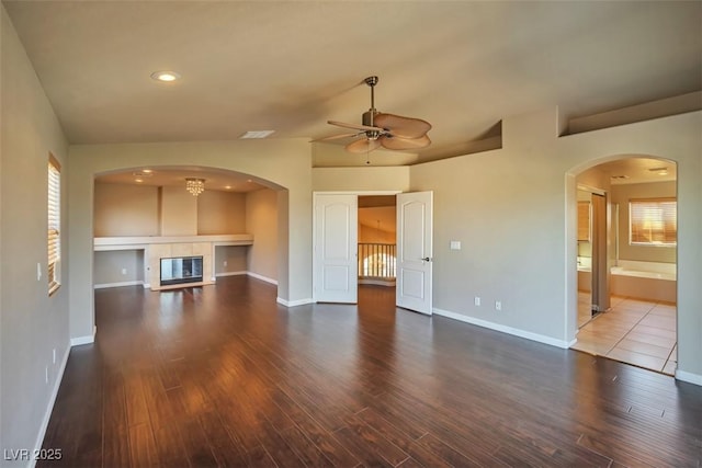 1740 Flores Ln, Henderson, NV 89012 - unfurnished living room featuring ceiling fan, wood finished floors, a glass covered fireplace, baseboards, and recessed lighting
