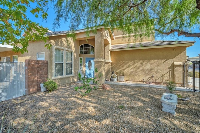 1740 Flores Ln, Henderson, NV 89012 - view of front of house featuring stucco siding and a gate