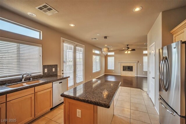 1740 Flores Ln, Henderson, NV 89012 - kitchen with appliances with stainless steel finishes, a sink, recessed lighting, light tile patterned floors, and ceiling fan