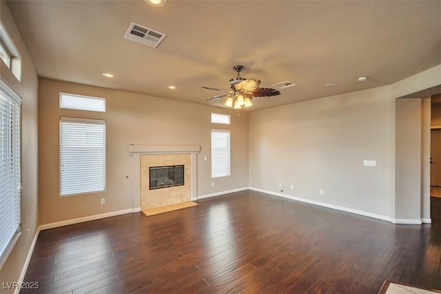 1740 Flores Ln, Henderson, NV 89012 - unfurnished living room featuring a tiled fireplace, a ceiling fan, baseboards, dark wood-type flooring, and recessed lighting