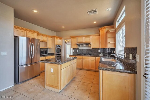 1740 Flores Ln, Henderson, NV 89012 - kitchen featuring appliances with stainless steel finishes, light brown cabinets, open shelves, tasteful backsplash, and a kitchen island
