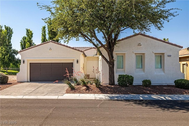 5747 Jaborandi Ave, Pahrump, NV 89061 - mediterranean / spanish-style house featuring stucco siding, an attached garage, driveway, and a tiled roof