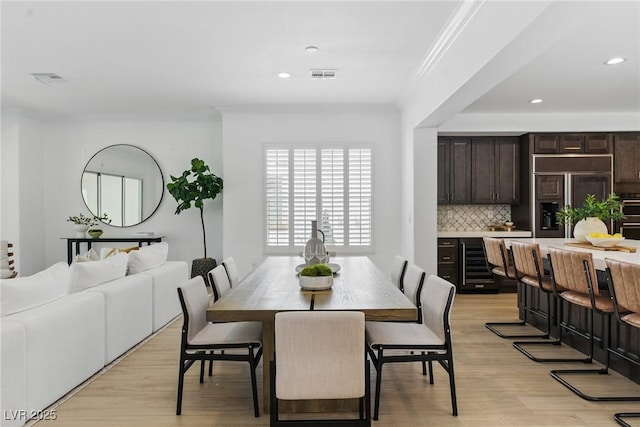 11775 Woodbrook Ct, Las Vegas, NV 89141 - dining room featuring ornamental molding, light wood finished floors, beverage cooler, and recessed lighting