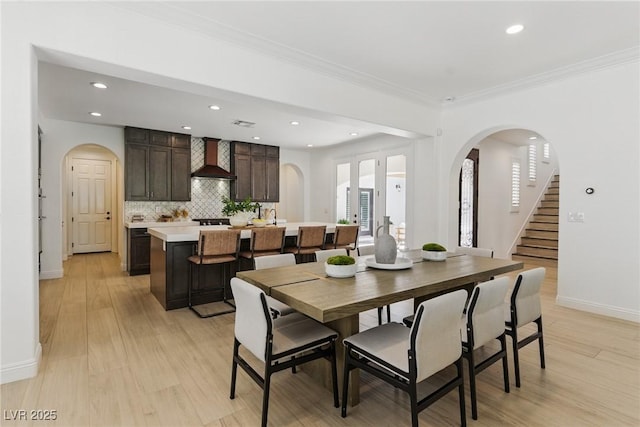 11775 Woodbrook Ct, Las Vegas, NV 89141 - dining room featuring arched walkways, recessed lighting, baseboards, ornamental molding, and light wood finished floors