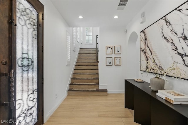 11775 Woodbrook Ct, Las Vegas, NV 89141 - entrance foyer with light wood-style floors, baseboards, recessed lighting, stairway, and arched walkways