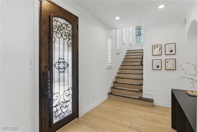 11775 Woodbrook Ct, Las Vegas, NV 89141 - foyer entrance with baseboards, stairway, light wood-type flooring, recessed lighting, and arched walkways