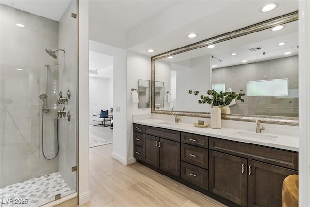 11775 Woodbrook Ct, Las Vegas, NV 89141 - bathroom with double vanity, a stall shower, recessed lighting, and baseboards